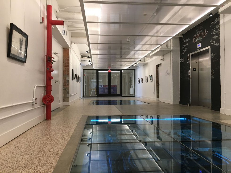 A glass floor offers a view of the old boiler room in cSPACE