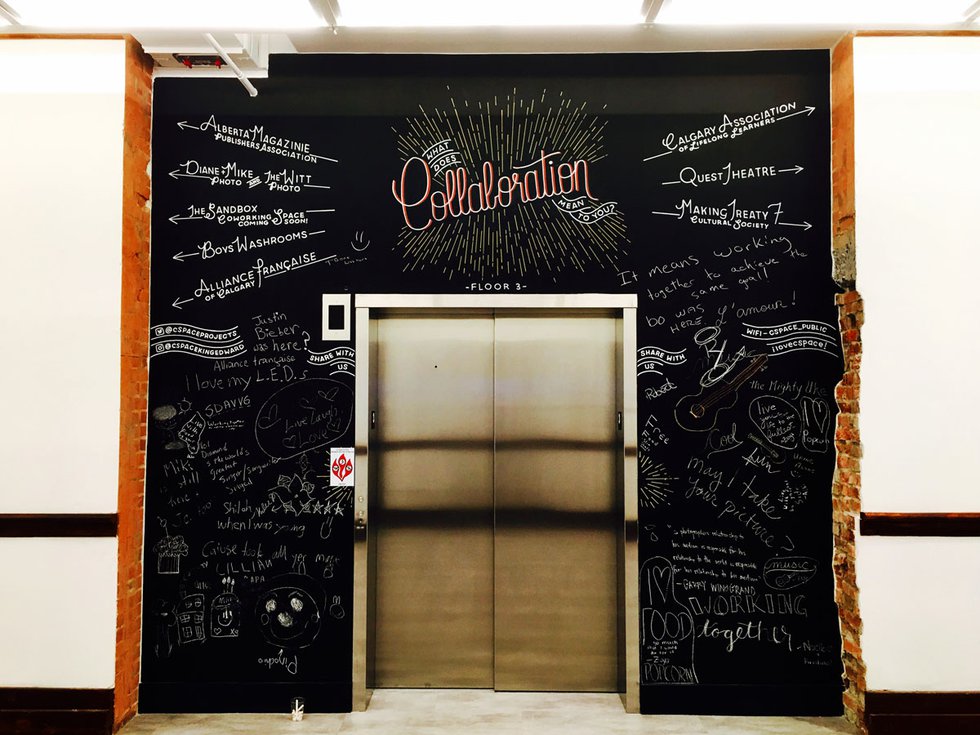 A chalkboard frames the elevator in the repurposed school