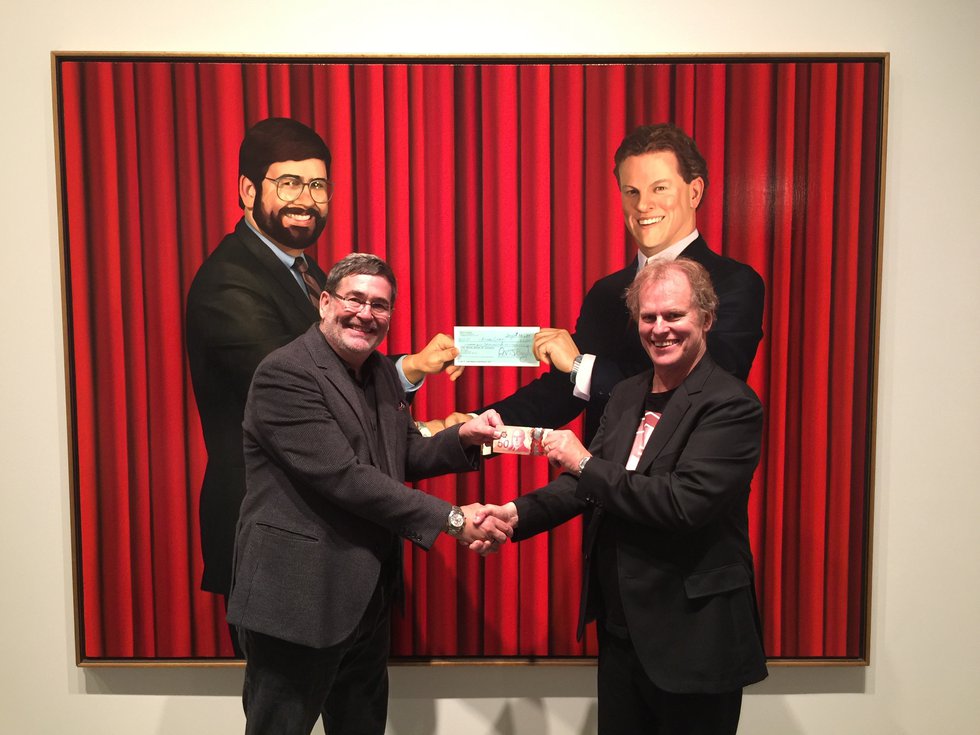 Peter Boyd and Chris Cran re-enact "The Cheque" depicting an early purchase prompted by Boyd's desire for a Cran painting when none was available and his willingness to go along with Cran's project. 2016 (photo by Jordan Boyd)