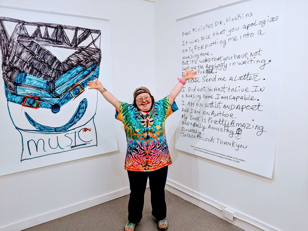 Teresa Pocock stands in front of the hand-written letter she sent to the Ontario government. (Photo by Billiam James)