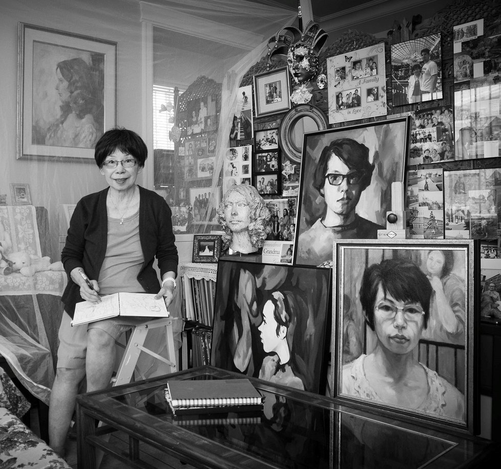 Betty Woo with sketchbook &amp; self-portraits (photo by Donna H. Hagerman)