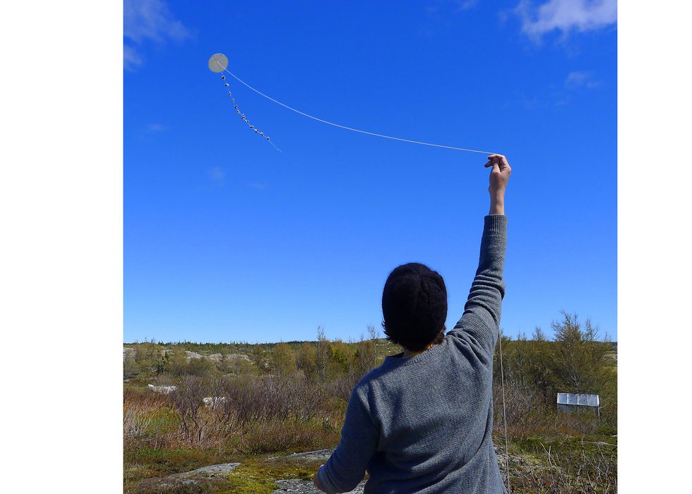 Flying a boulder kite at a 2018 workshop hosted by the Museum of the Flat Earth on Fogo Island, Nfld.