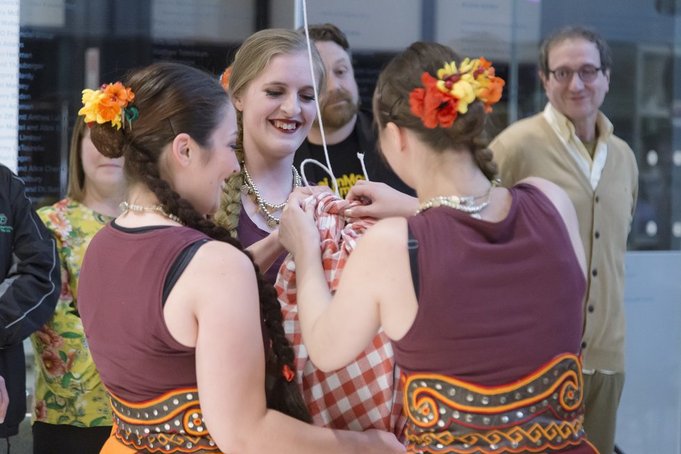 Ukrainian dancers open a bundle of custom-made diamond-shaped chocolates that were distributed to guests at the opening of Amalie Atkin's "The Diamond Eye Assembly" at the Remai Modern in Saskatoon earlier this year.