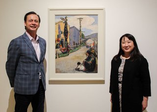 Curtis Collins, director, and curator Kiriko Watanabe, Gail with Emily Carr's "Street, Alert Bay," 1912