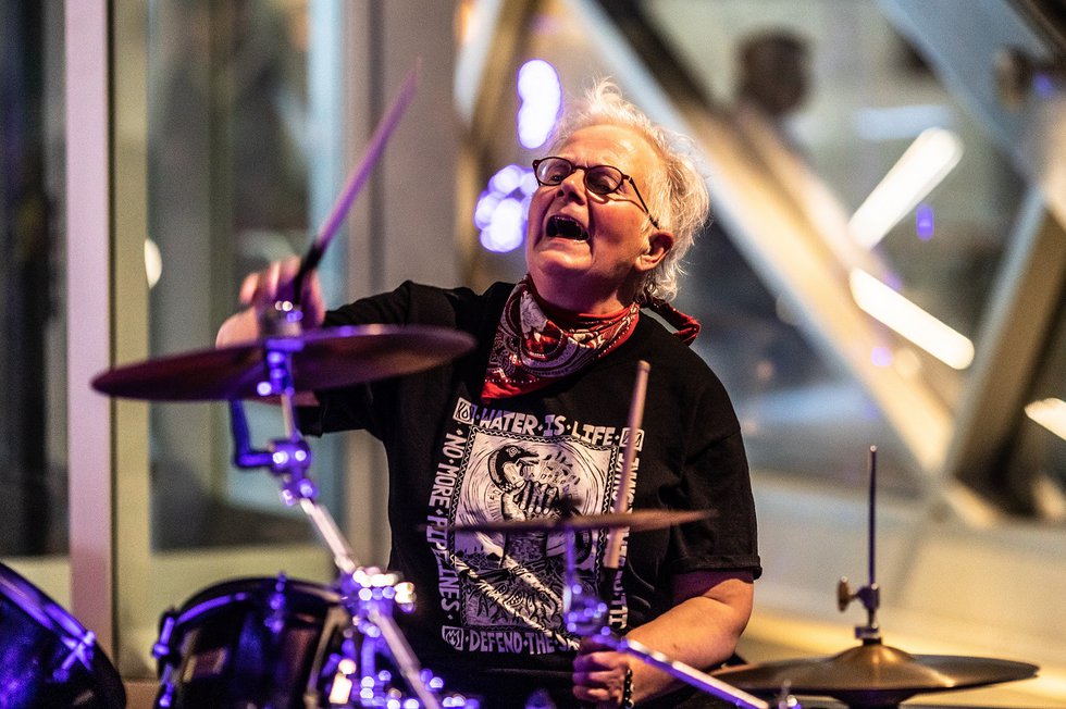 Calgary artist Rita McKeough on drums at the opening last month of a group show that includes her work, "Rebellious: Alberta Women Artists in the 1980s," at the Art Gallery of Alberta. (photo by Leroy Schulz)
