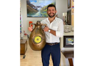 Tarek Nemr holds a ceremonial vase made by David Barnes at the Bluerock Gallery in Black Diamond, Alta. (courtesy Bluerock Gallery)