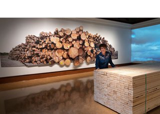 Fern Helfand poses with "Timber, Lumber, Wood, Home," 2021 (courtesy of artist)
