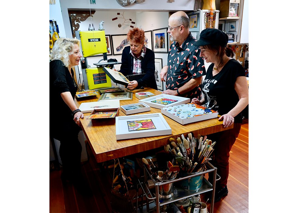 From left, Ali Ledgerwood, Valerie Arntzen, David Maclean and Ginger Sedlarova look at some of the art submitted by local artists to give as a gift to front-line workers for the arTHANKS project. (photo by Ric Ernst)