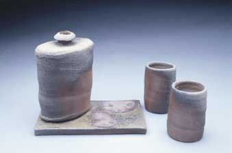 "Flask with two cups and tile"