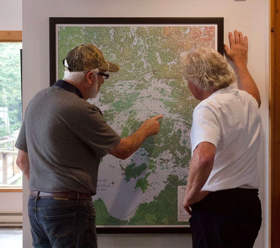 Winnipeg gallerist Bill Mayberry (left) and Randolph Parker chart the day’s route on Lake of the Woods. (courtesy Randolph Parker)
