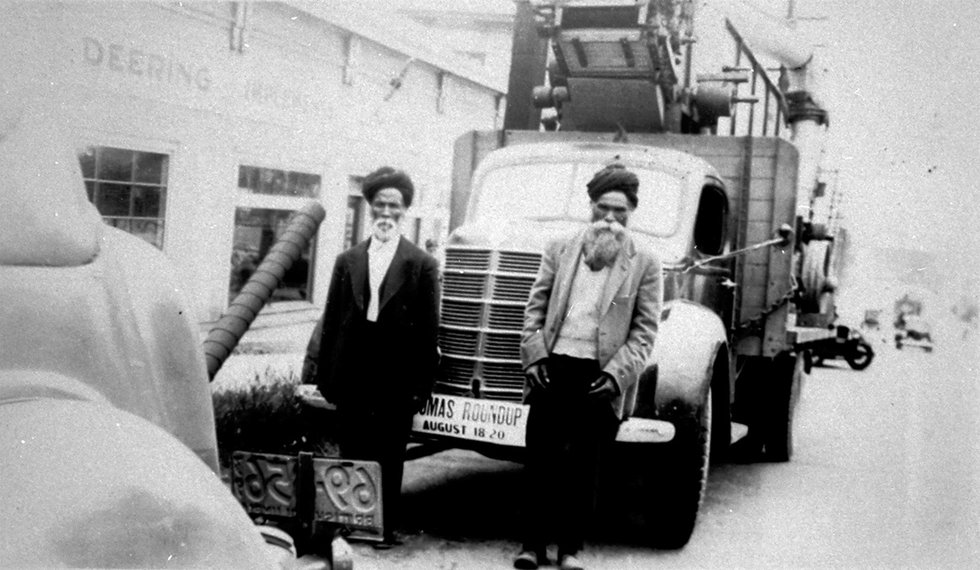 Sunder Singh Thandi, left, and Jassa Singh in front of a flatdeck truck. Taken on Main Street, Vancouver, 1939. (photo courtesy of The Reach Archives)