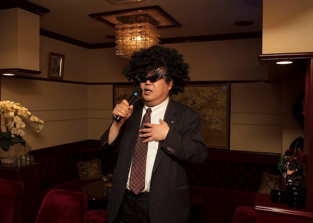 A regular at a “snack” in Fukuoka indulging in some karaoke (photo by Greg Girard)
