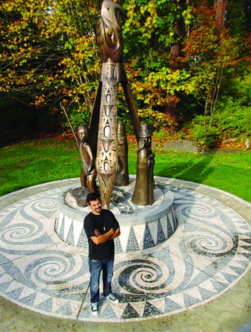 Ts’uts’umutl Luke Marston poses with his sculpture, "Shore to Shore"