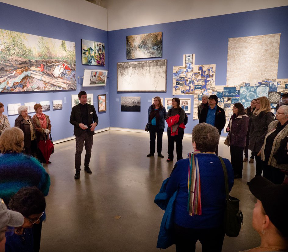 Curator Jordan Strom leads an exhibition tour.