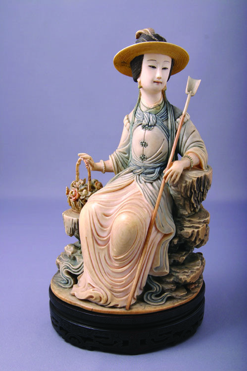 Xiang Fei holding a basket of flowers, Qing dynasty, Qianlong period, late 18th century, ivory with stained colours, 8” tall
