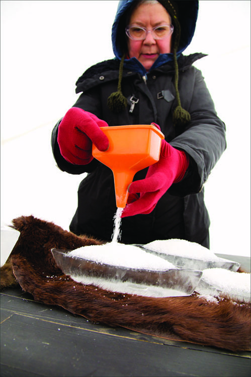 Elvira Finnigan pours salt on ice boats last year for Salt Trade at the RAW:almond pop-up restaurant on the Red River.