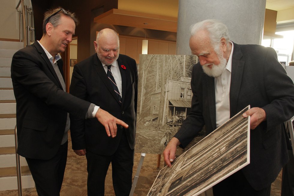 L-R Reid Shier (Presentation House Gallery), Rainer Müller (PARC), and Uno Langmann (Collector) view excerpts from a Presentation House exhibit following a $250,000 donation from PARC to PHG’s new Polygon Gallery
