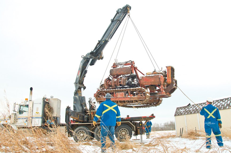 Workers load a trencher in Fort St. John, last February