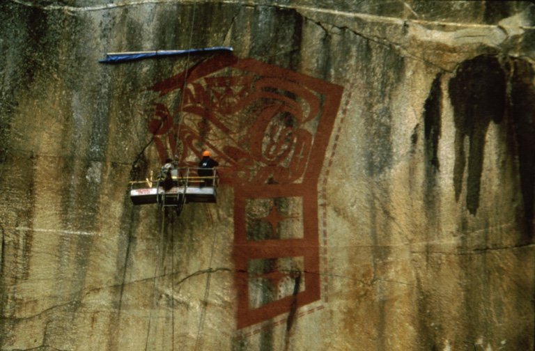 Marianne Nicolson, Documentation of painting a large petrograph on a cliff in Kingcome Inlet, British Columbia to mark the continued vitality of her ancestral village of Gwa’yi," 1998